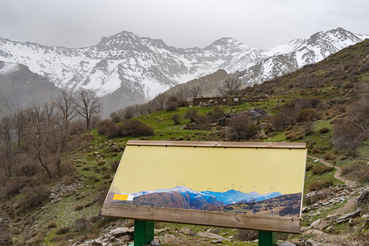 Interpretative sign with Mulhacen and Alcazaba mountains in the background
