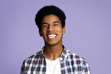 Perfect Teeth. African-American Guy Widely Smiling over Pink Studio Background