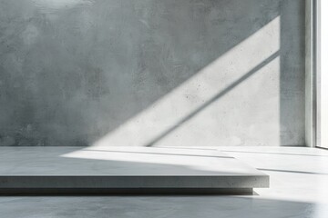 Empty white studio with grey kitchen table and concrete backdrop.