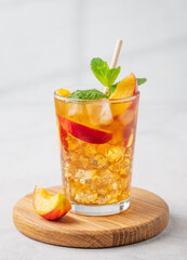 Refreshing peach iced mint tea. The concept of a healthy homemade cold summer drink
