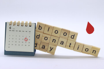 Blood donation day marked in the calendar with copy a blood drop in the left side and the letters in wood writing Blood donation day