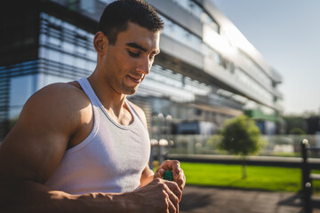 man young male athlete hold bottle of water drink training outdoor