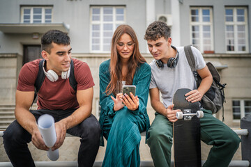 group of teenage students gen z sit outdoor use mobile phone smartphone