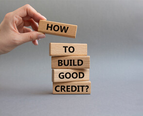 How to build good credit symbol. Concept words How to build good credit on wooden blocks. Beautiful grey background. Businessman hand. Business and How to build good credit concept. Copy space.