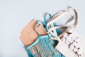 Refusal of plastic bags, string bag, textile bag, paper bags and cotton branch on blue