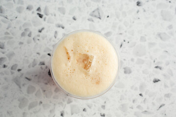 A top down view of a shaken iced tea drink.