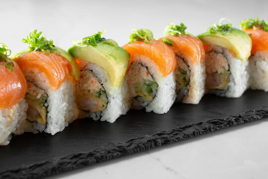 A closeup view of a salmon avocado sushi roll.