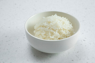 A closeup view of a small bowl of steamed white rice.