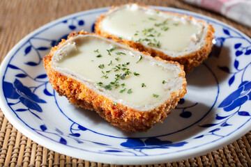 A closeup view of a plate of cheese katsu.