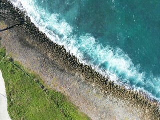 Rocky shore if a beach in San Andres Island, Colombia. The waves crushes against the shore and produce white foam and beautiful patterns