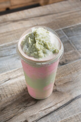 A view of a layered strawberry avocado milk tea.