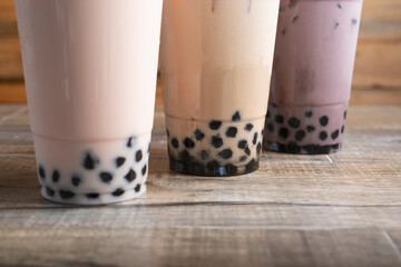 A view of some drinks featuring boba topping at the bottom of the cup.