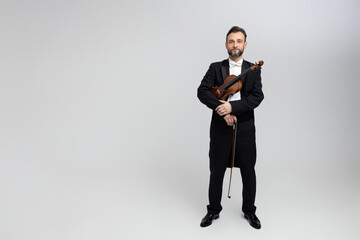 Elegant man violinist on stage at concert