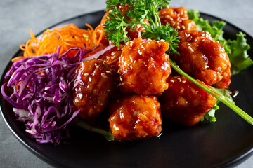 A closeup view of a plate of orange chicken.