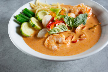 A view of a bowl of seafood red curry.