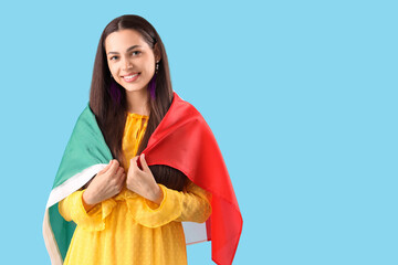 Young woman with Mexican flag on blue background