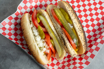 A top down view of two Chicago hot dogs.
