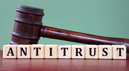 ANTITRUST - word on wooden cubes on background of judge's gavel
