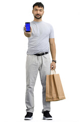 A man, full-length, on a white background, with bags and a phone