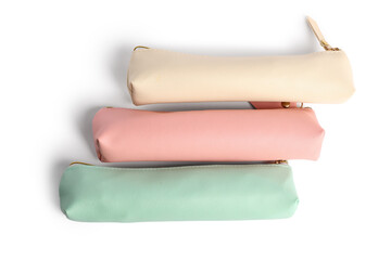 Different pencil cases on white background