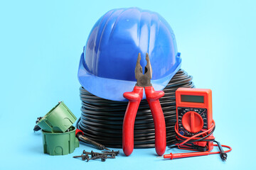Set of different electrician's supplies on color background