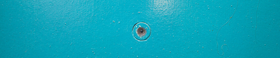 door peephole embedded in the door close-up with a beautiful texture of the painted entrance group