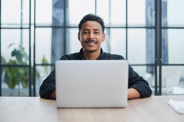 Creative Businessman Working at Desk with Laptop in Modern Office