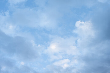 Clean blue and white sky nature background, medium blue sky with painterly white and blue clouds
