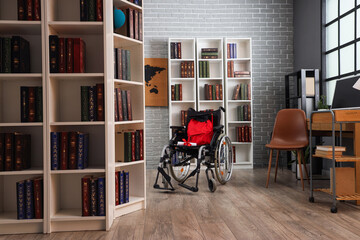 Wheelchair with diploma and backpack in library