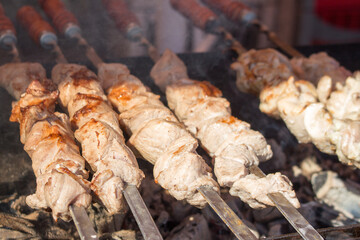 Appetizing kebab is baked on hot coals