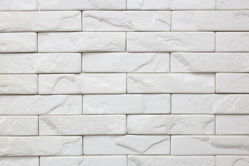 A white brick wall with rough texture
