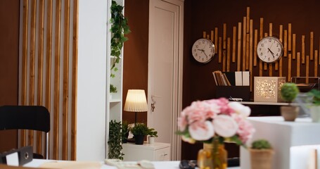 Empty hotel reception entryway with glamorous decorations used to attract visitors and important clients. Registration counter and lounge area decorated with classy stylish furniture, tourism.