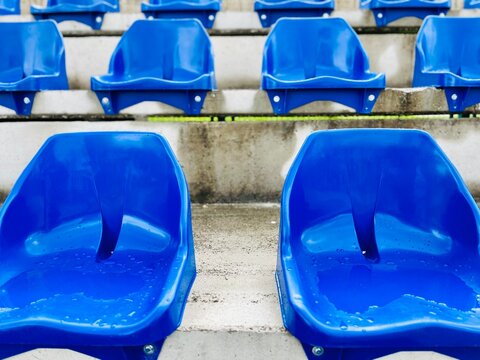 Close-up of rows of blue plastic seats at an empty basketball stadium, Bosnia and Herzegovina