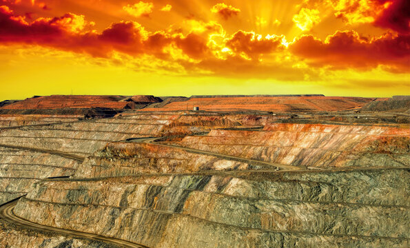 Dramatic yellow and orange sunset over a super Pit Gold mine, Kalgoorlie, Western Australia, Australia