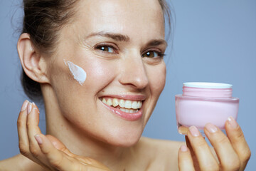 happy young 40 years old woman with cosmetic cream jar