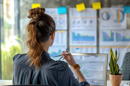 A business women reviewing project on big monitor screen