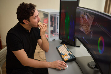 Focused creative man working editing video footage in creative office studio.