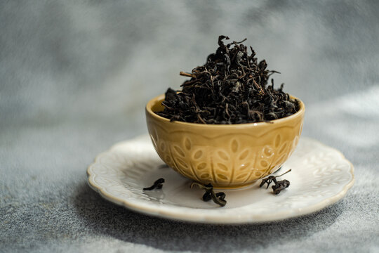 Close-up of a Ceramic bowl filled with loose leaf tea on a table