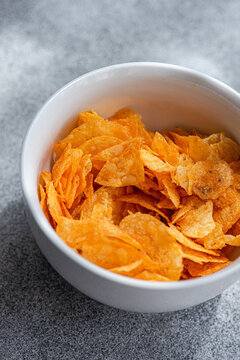 Close-up overhead view of a bowl of paprika crisps