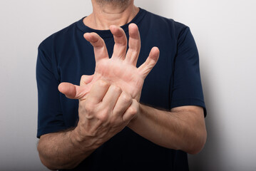 Middle aged man scratching his hand. Skin disease. Allergic reaction.