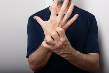 Middle aged man scratching his hand. Skin disease. Allergic reaction.