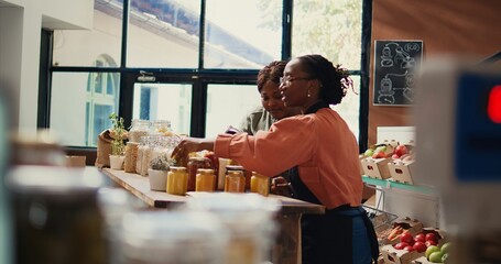 Retailer showing natural homemade sauces in reusable jars, recommending organic products to support...