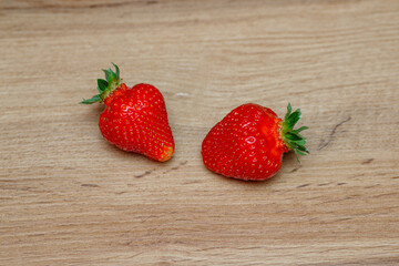 Fresh delicious selected strawberries on a brown wooden table