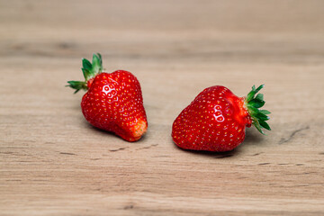 Fresh delicious selected strawberries on a brown wooden table