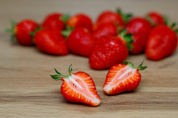 Fresh delicious selected strawberries on a brown wooden table