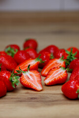 Fresh delicious selected strawberries on a brown wooden table