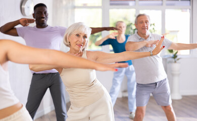 Senior woman and friends people dancing in studio or gym doing sports or practicing dance number....