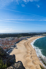 Fototapeta premium View from the hill to the sandy beach 'Praia da Nazaré' , Praia do Norte beach and Nazare town, Portugal