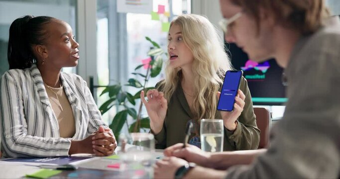 Business people, designers and meeting with phone for app, software development or innovation at office. Group of employees in team discussion for UI, interaction or engagement on mobile smartphone