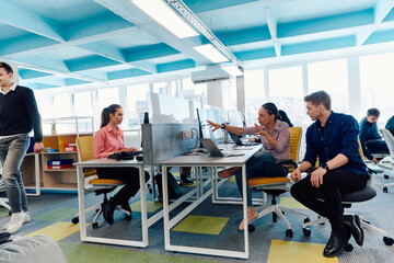 Fototapeta premium Collaborative process of multicultural skilled young business team during brainstorming meeting in office.Diverse group of young people dressed in formal wear cooperating on developing design project